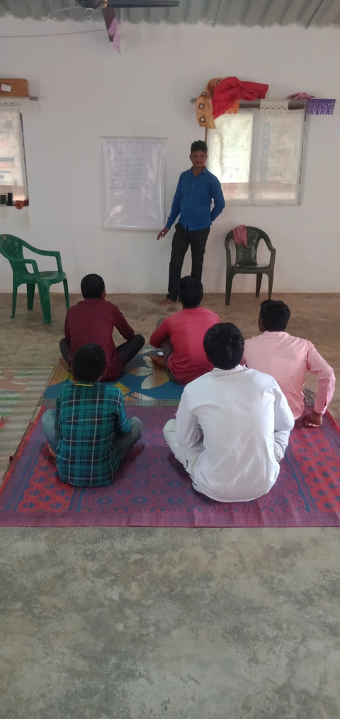Pastor is teaching to the youth who are not able to read and write
